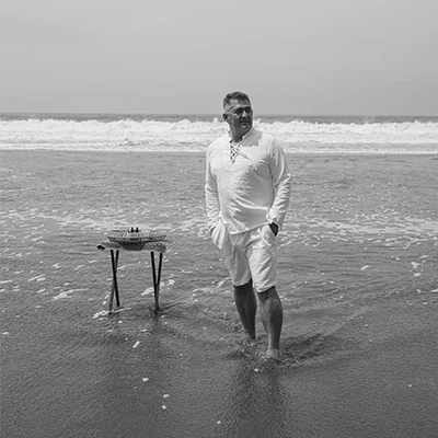 Erick standing in the ocean.